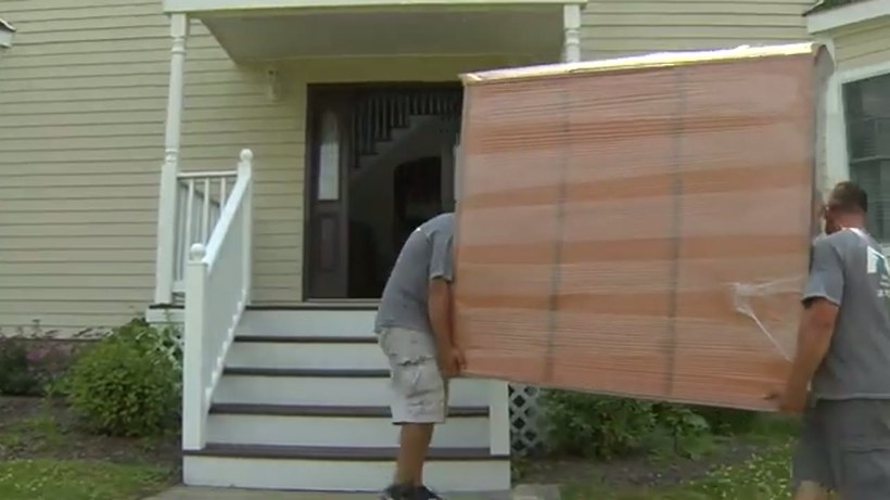 Conan Moving crew handling a piece on a DFW job